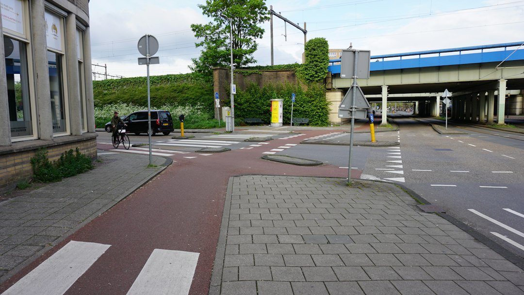 a city street with a car parked on the side of the road